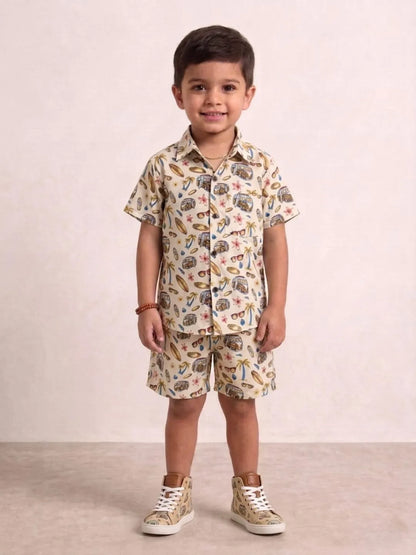 Child wearing a patterned shirt and shorts set with sneakers on a plain background