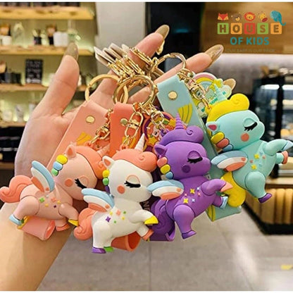Hand holding colorful keychains with cartoon designs in a store setting.
