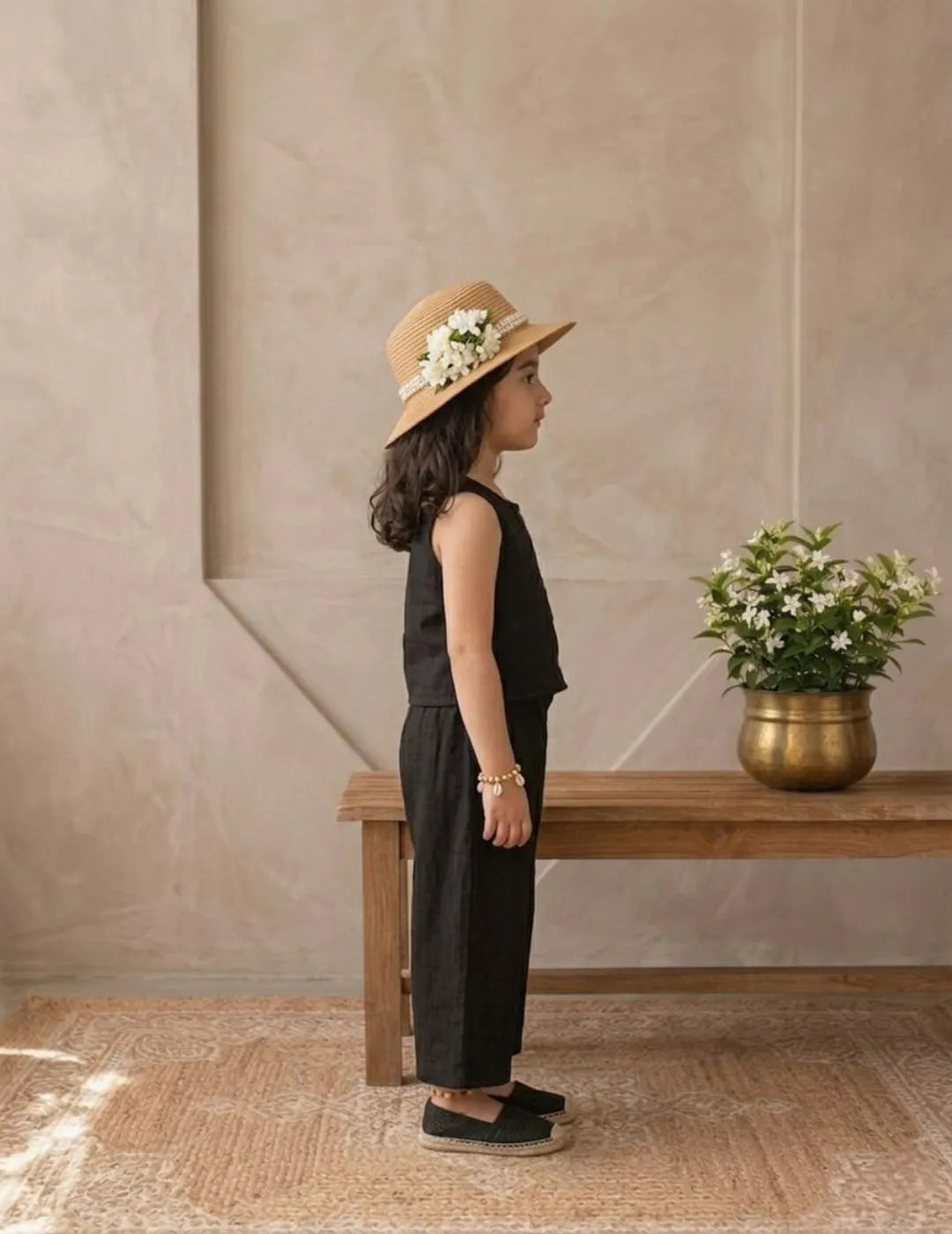 Side profile of girl wearing black cotton co-ord set with wide-leg pants