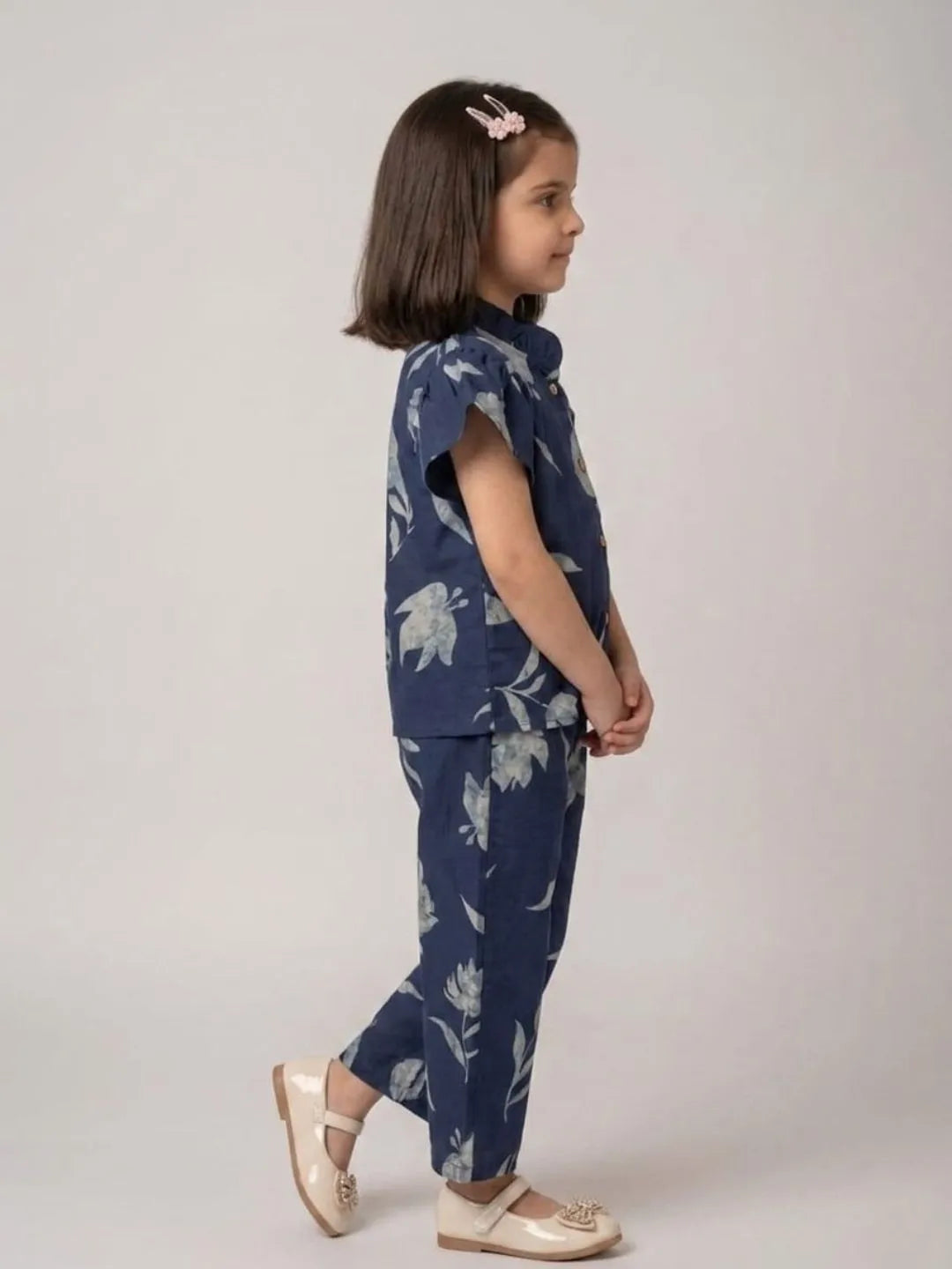 Side view of girls blue floral cotton co-ord set with flutter sleeves