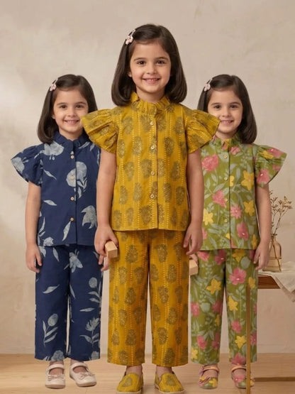 Girls cotton co-ord sets in blue floral, mustard printed, and green floral designs front view
