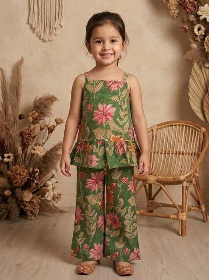 Girl wearing green floral co-ord set with sleeveless peplum top and wide leg pants front view