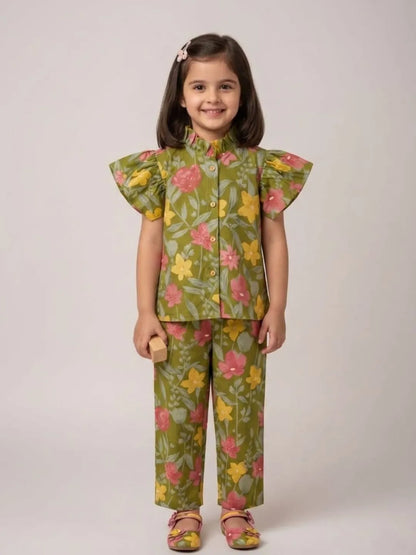 Girl wearing green floral cotton co-ord set with flutter sleeves front view