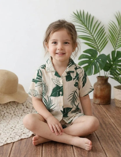 girl sitting wearing leaf print co-ord set shirt and shorts summer outfit