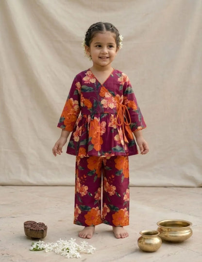 girl wearing maroon floral wrap co-ord set front view top and pants