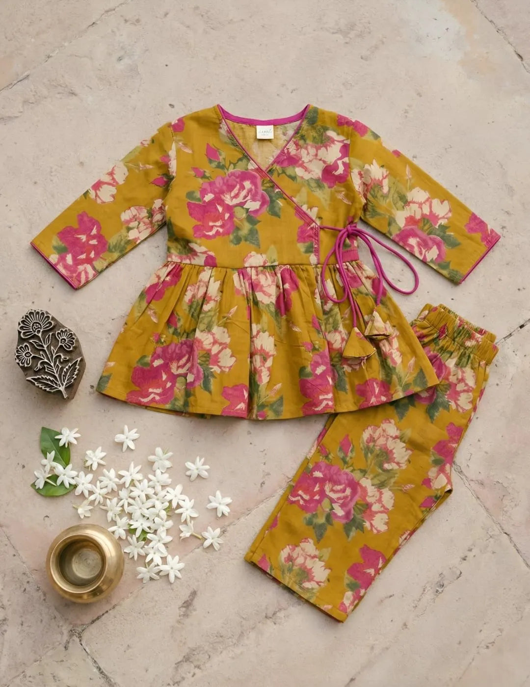 stylish girls mustard floral outfit front view peplum top and pants