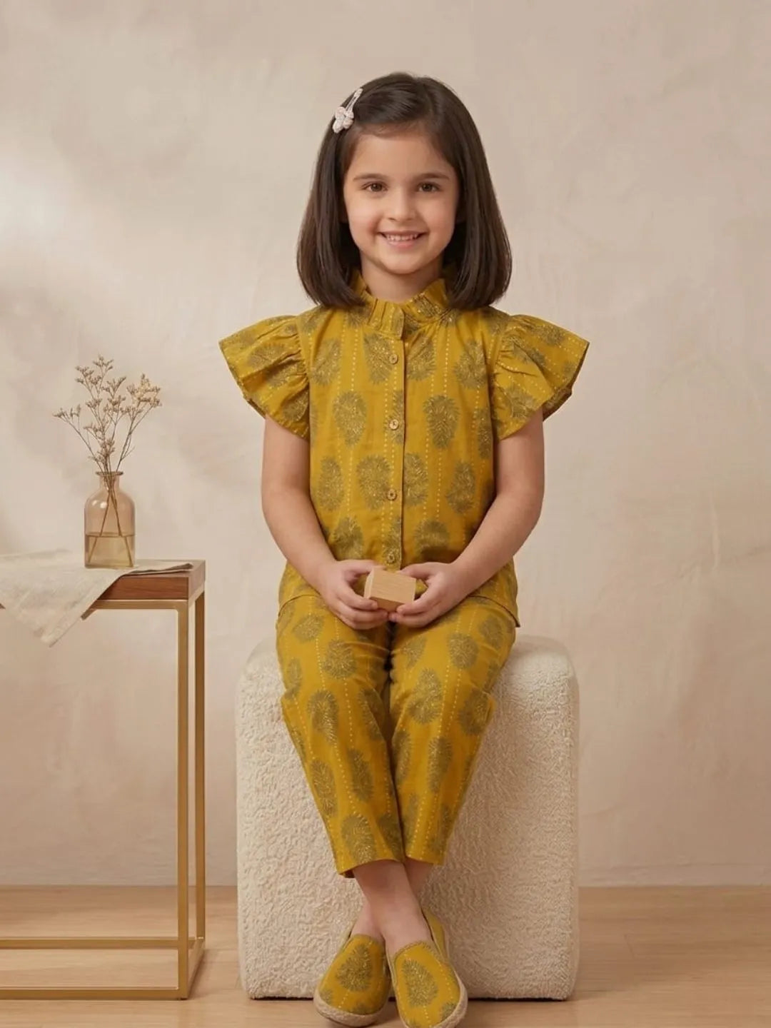 Girl sitting in mustard printed cotton co-ord set for summer outings