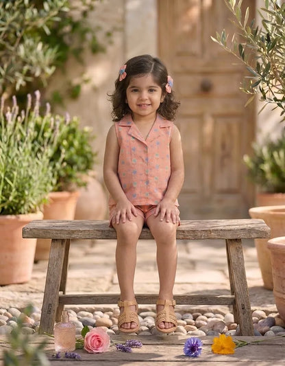 Toddler girl wearing peach pastel floral sleeveless co-ord set sitting pose