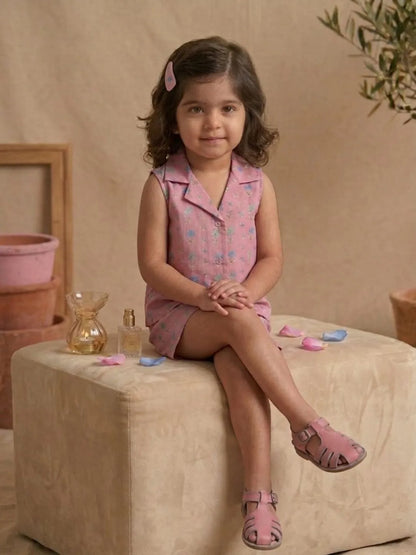 Toddler girl wearing pink pastel floral sleeveless co-ord set sitting pose