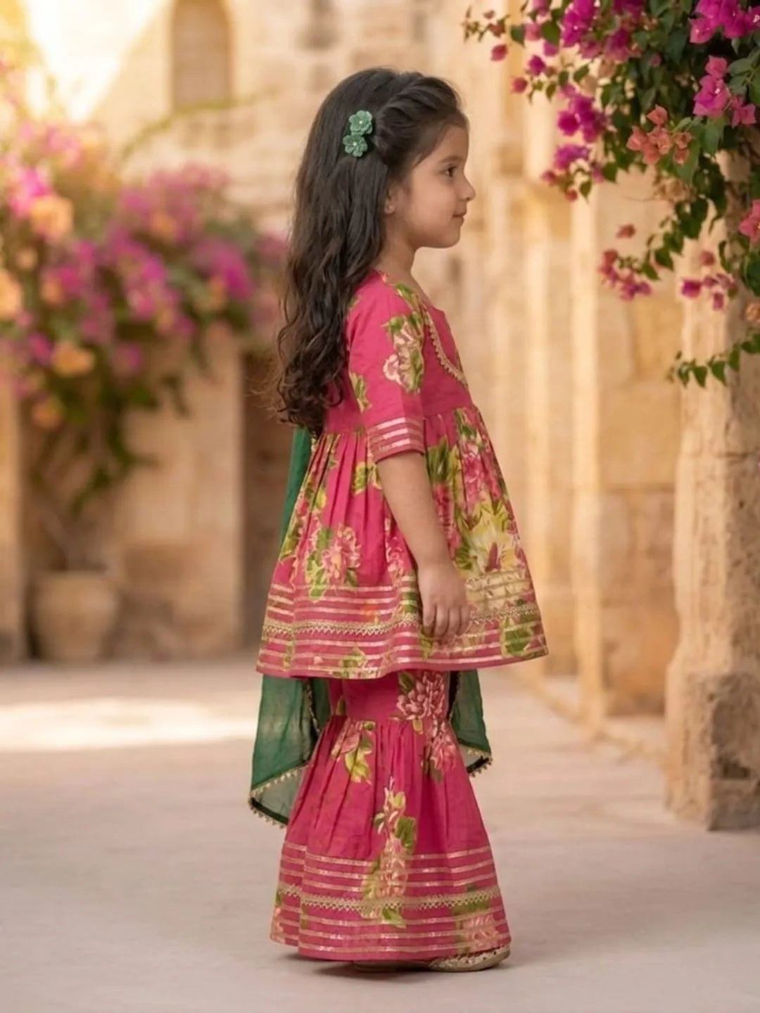 Side view of girls pink floral kurta sharara set with dupatta
