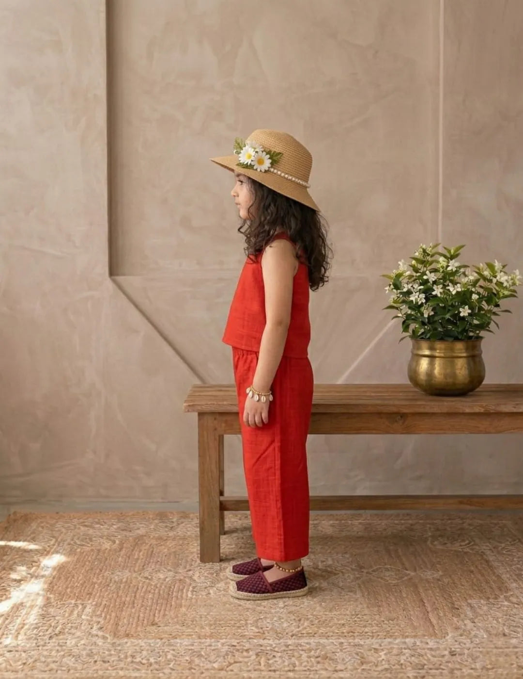 Side view of girl wearing red cotton co-ord set with stylish wide-leg pants