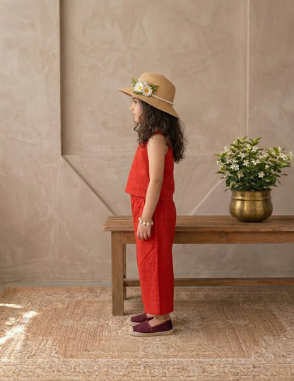 Side view of girl wearing red cotton co-ord set with stylish wide-leg pants