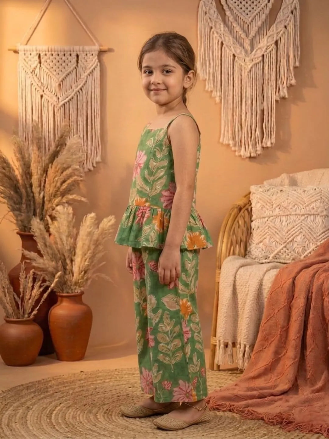 Side view of girls green floral co-ord set with sleeveless peplum top and wide leg pants