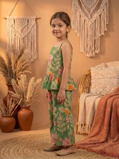 Side view of girls green floral co-ord set with sleeveless peplum top and wide leg pants