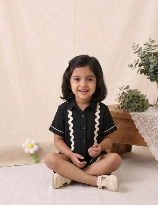 Close up of wavy contrast detailing on black cotton co-ord set shirt