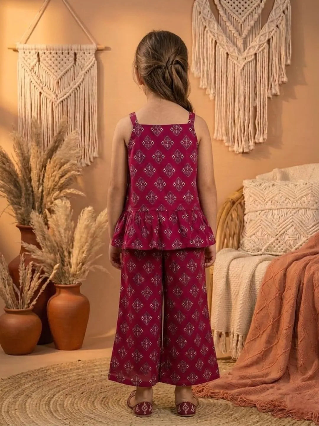 Back view of girls red printed co-ord set with sleeveless top and wide leg pants